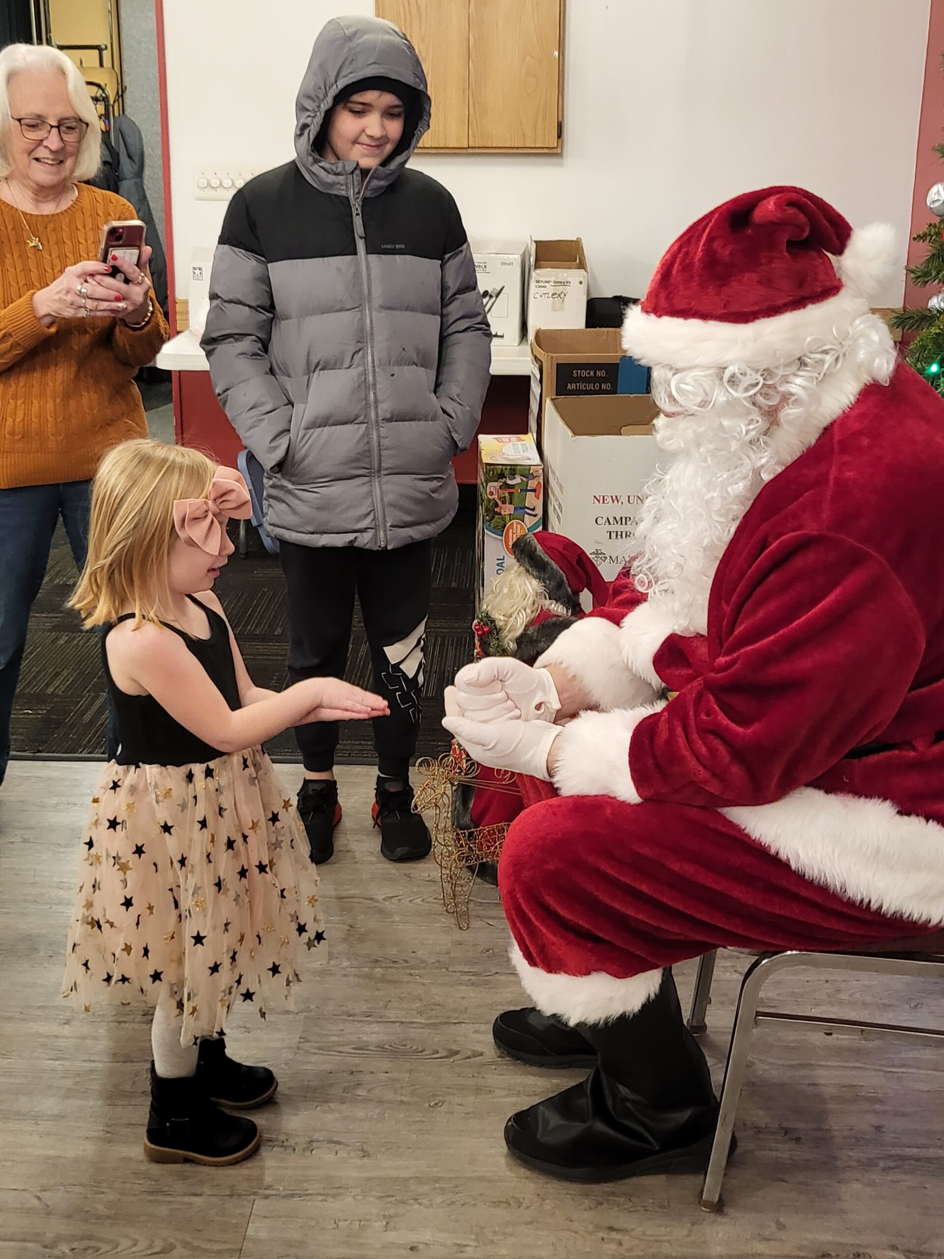Young sweetie plays rock, paper scissors with Santa!